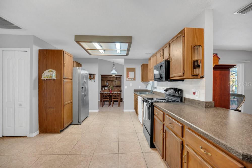 90 Sundown Road DeBary, FL 32713 - Photo 12 of 36 a kitchen with stainless steel appliances granite countertop a refrigerator a stove top oven a sink and dishwasher