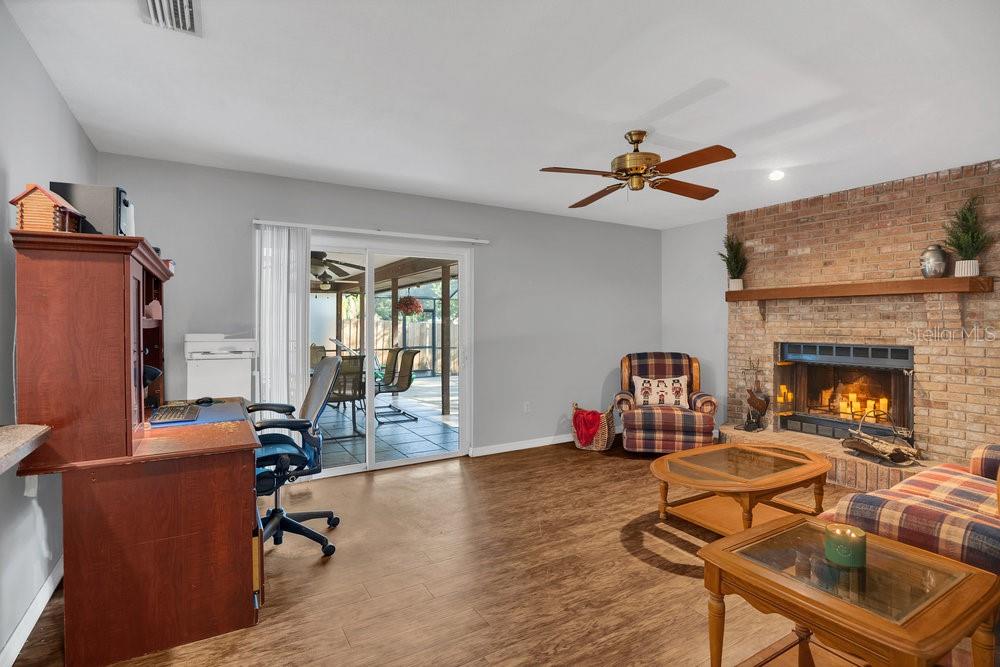 90 Sundown Road DeBary, FL 32713 - Photo 14 of 36 a living room with furniture a fireplace and a flat screen tv