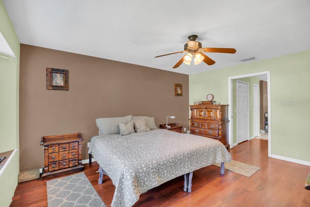 90 Sundown Road DeBary, FL 32713 - Photo 17 of 36 a bedroom with a bed and wooden floor