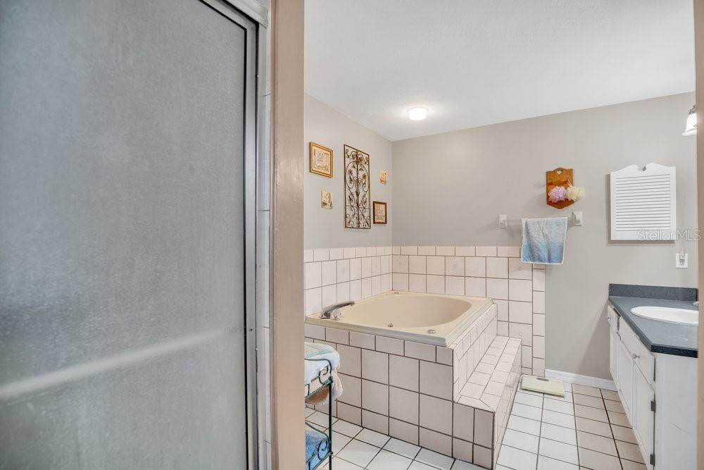 90 Sundown Road DeBary, FL 32713 - Photo 19 of 36 a bathroom with a sink a toilet and shower