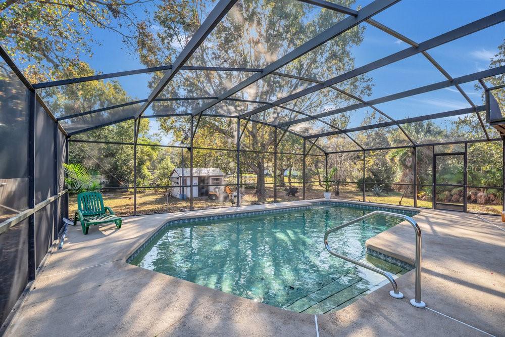 90 Sundown Road DeBary, FL 32713 - Photo 25 of 36 a view of a swimming pool with a patio and a yard