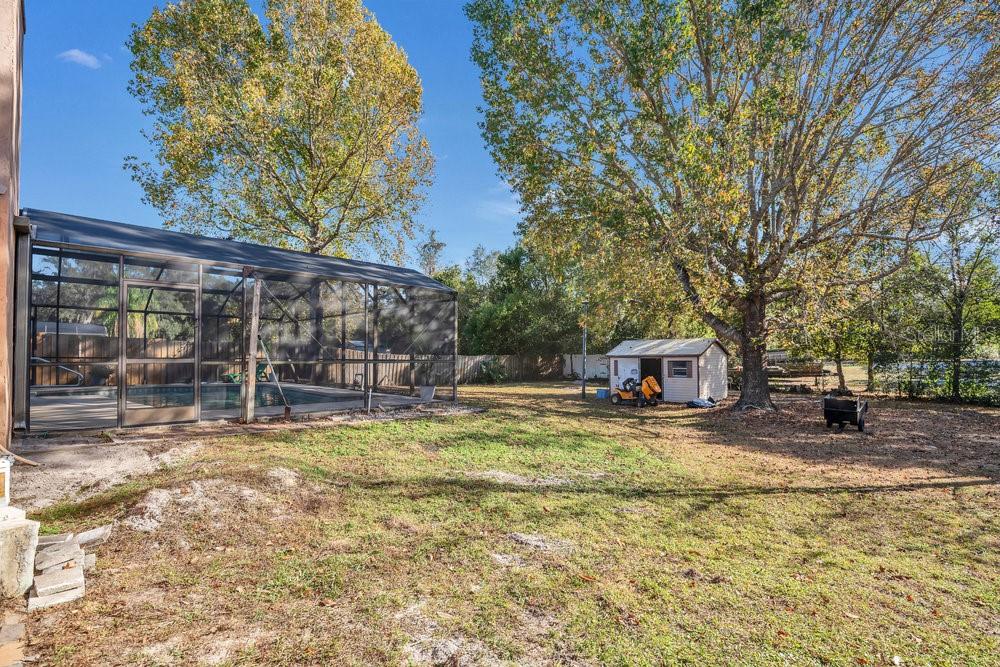 90 Sundown Road DeBary, FL 32713 - Photo 28 of 36 a view of a house with swimming pool and sitting area