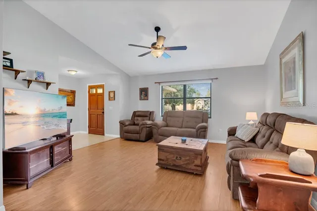 a living room with furniture fireplace and a window