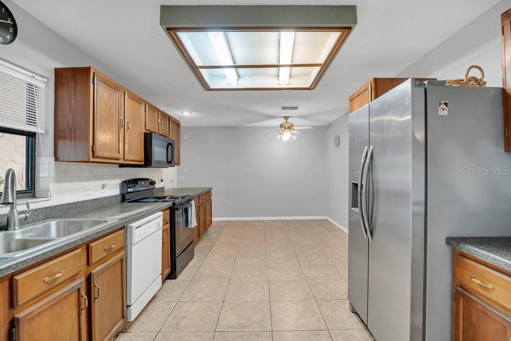 90 Sundown Road DeBary, FL 32713 - Photo 10 of 36 a kitchen with stainless steel appliances granite countertop a refrigerator and a sink