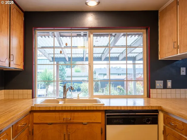 a kitchen with a sink and large window