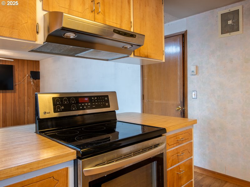 2563 York Street Eugene, OR 97404 - Photo 12 of 44 a stove top oven sitting inside of a kitchen