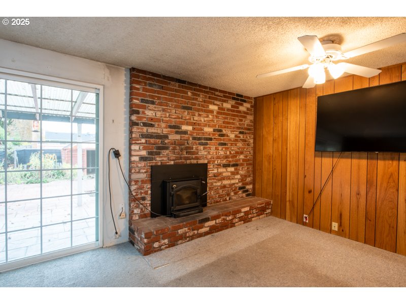 2563 York Street Eugene, OR 97404 - Photo 15 of 44 a living room with fireplace furniture and a flat screen tv