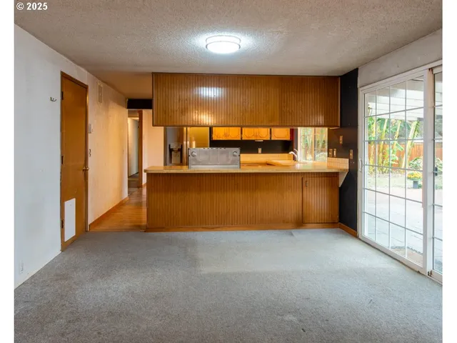 a view of a kitchen with a sink and cabinets