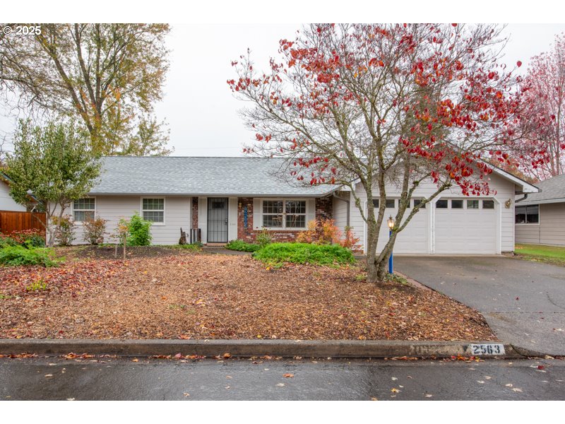 2563 York Street Eugene, OR 97404 - Photo 2 of 44 a front view of a house with a yard and garage