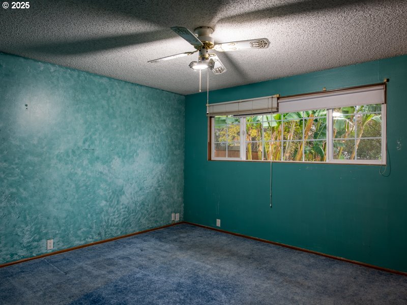 2563 York Street Eugene, OR 97404 - Photo 22 of 44 an empty room with a window and a fan