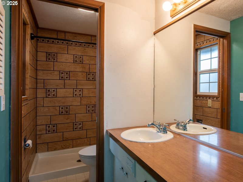 2563 York Street Eugene, OR 97404 - Photo 24 of 44 a bathroom with a granite countertop sink and a mirror
