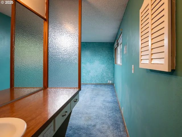 an empty room with a ceiling fan and a window