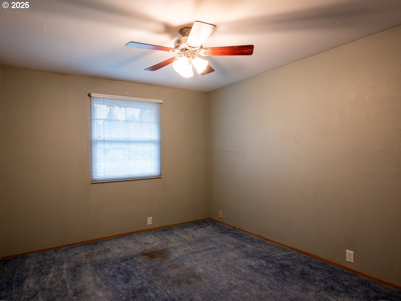 2563 York Street Eugene, OR 97404 - Photo 28 of 44 an empty room with a chandelier fan and windows