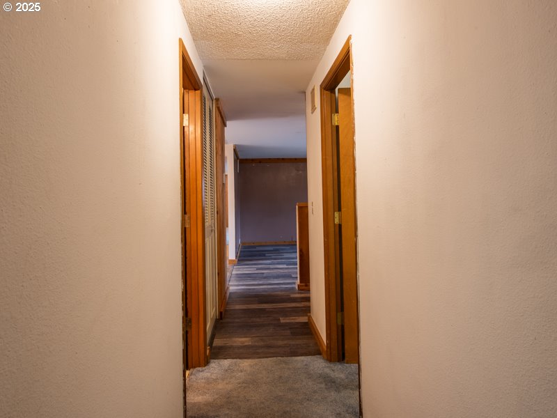 2563 York Street Eugene, OR 97404 - Photo 36 of 44 a view of a hallway with wooden floor and stairs