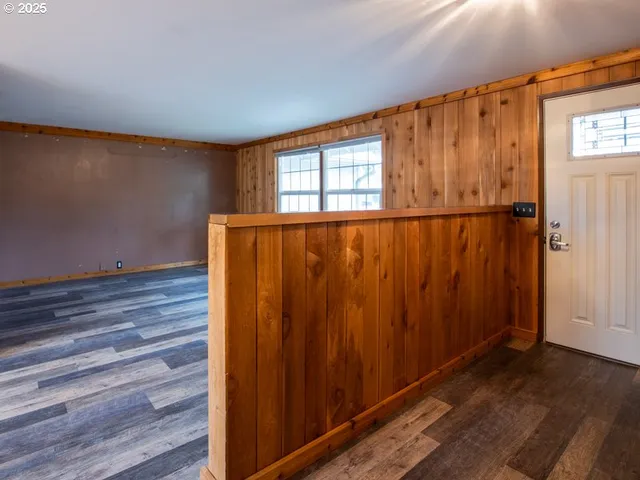 a view of a room with wooden floor and fan