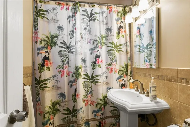 a bathroom with a sink and mirror with painted walls