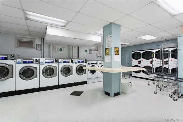a utility room with multiple dryer and washer
