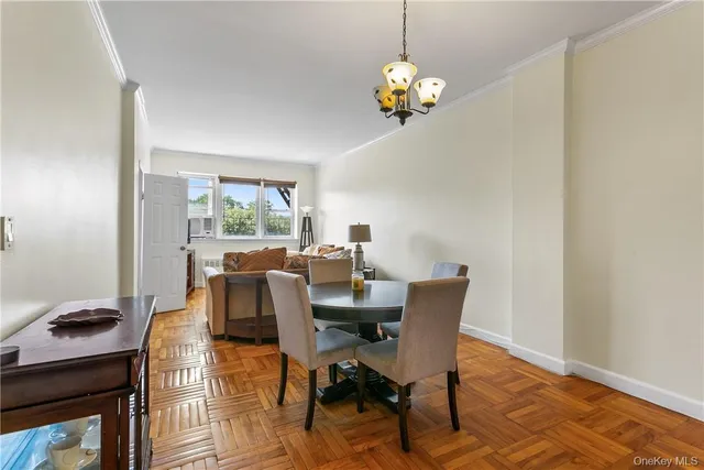 a view of a dining room with furniture wooden floor and chandelier