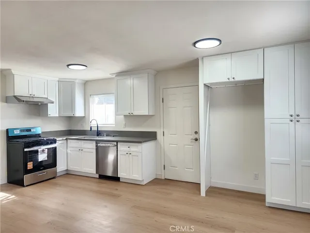 a kitchen with a sink cabinets and stainless steel appliances