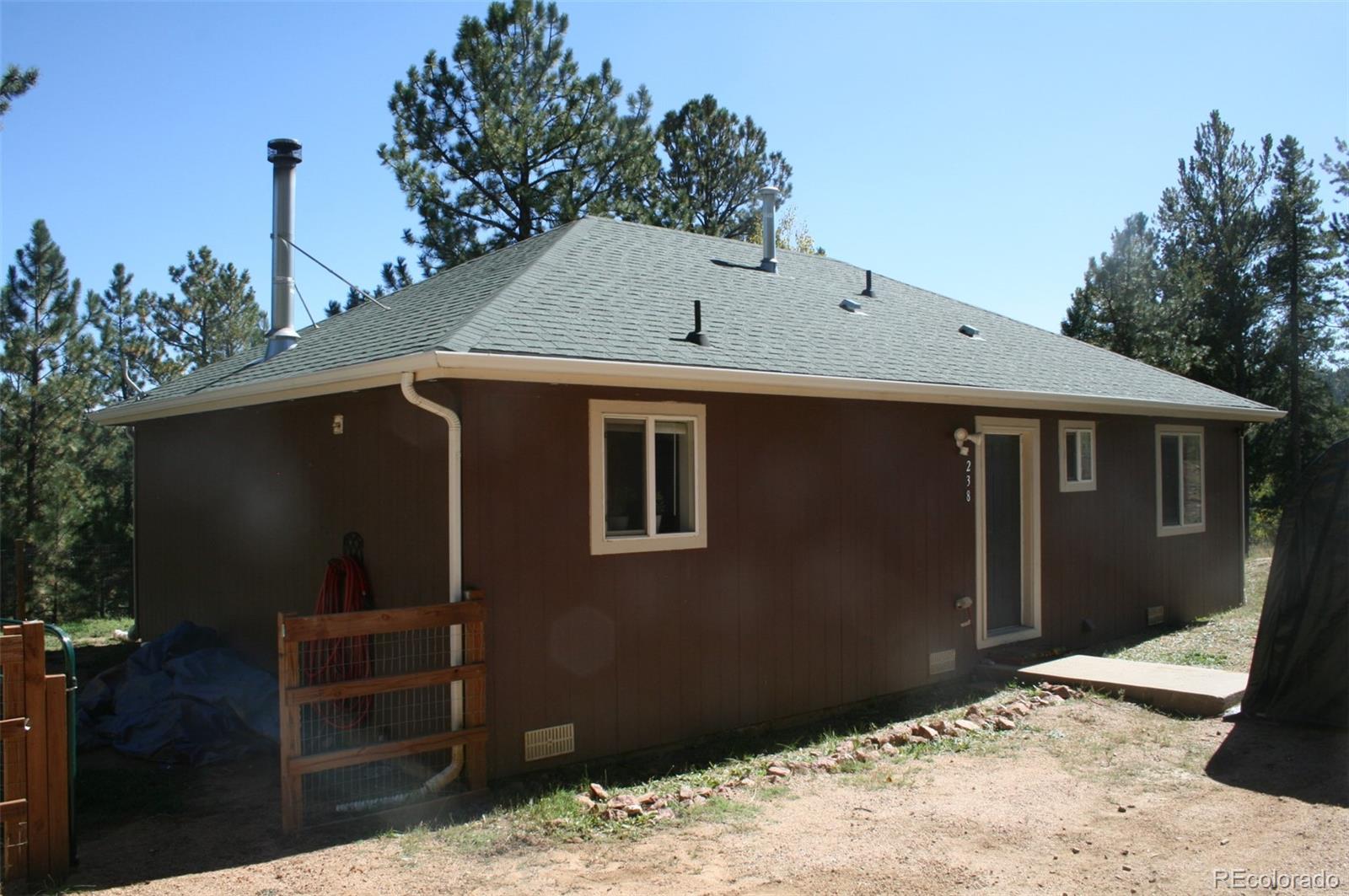 a backyard of a house with wooden fence
