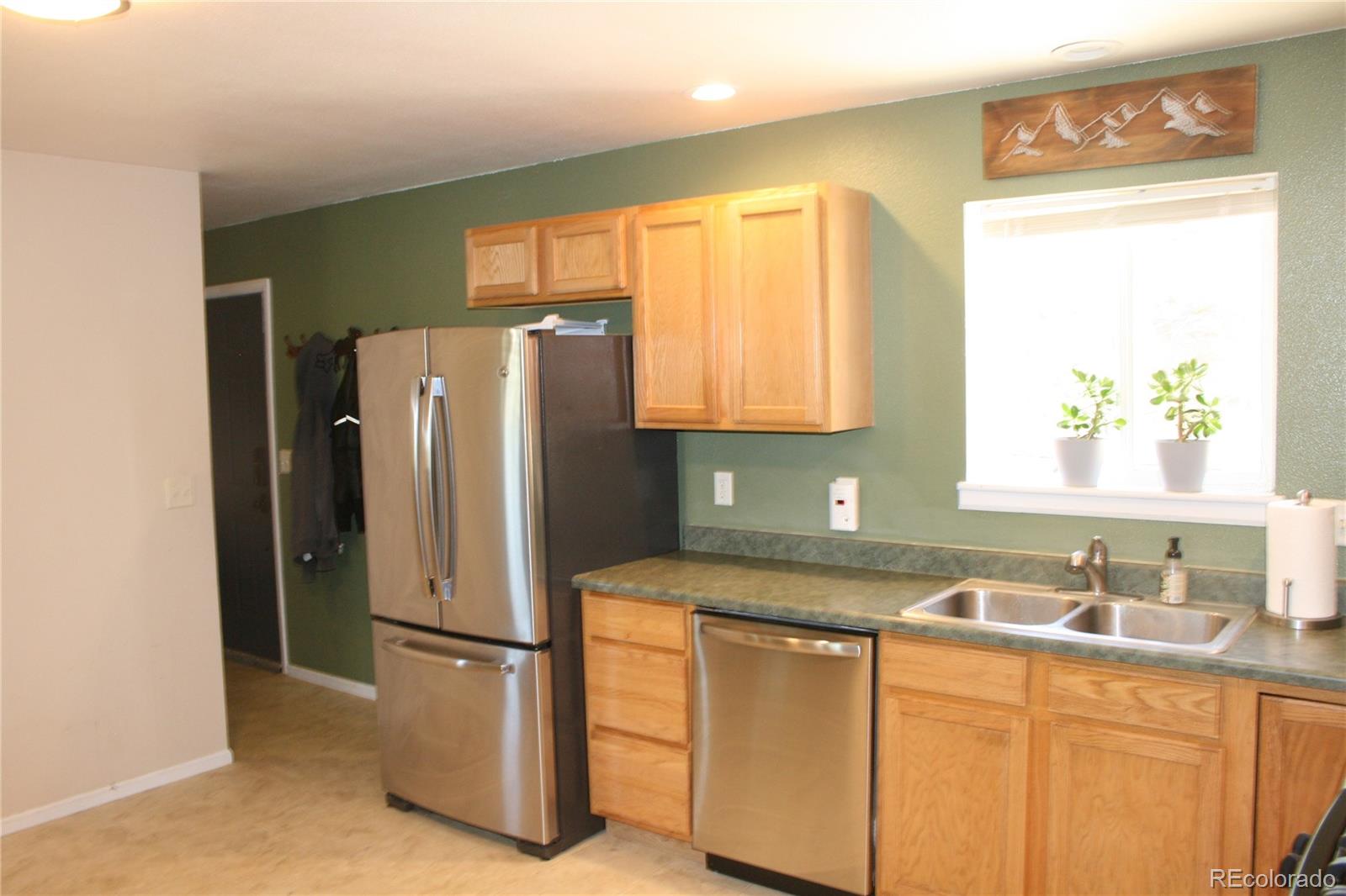238 Taylor Street Bailey, CO 80421 - Photo 13 of 23 a kitchen with stainless steel appliances granite countertop a refrigerator and a sink
