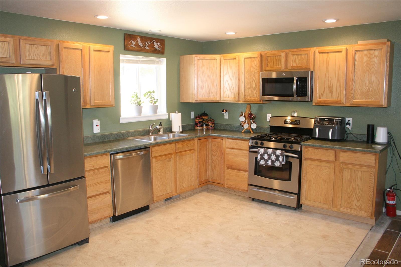 238 Taylor Street Bailey, CO 80421 - Photo 16 of 23 a kitchen with granite countertop a refrigerator sink and microwave