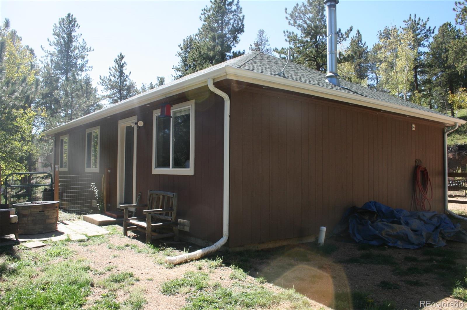 238 Taylor Street Bailey, CO 80421 - Photo 2 of 23 a backyard of a house with lots of green space