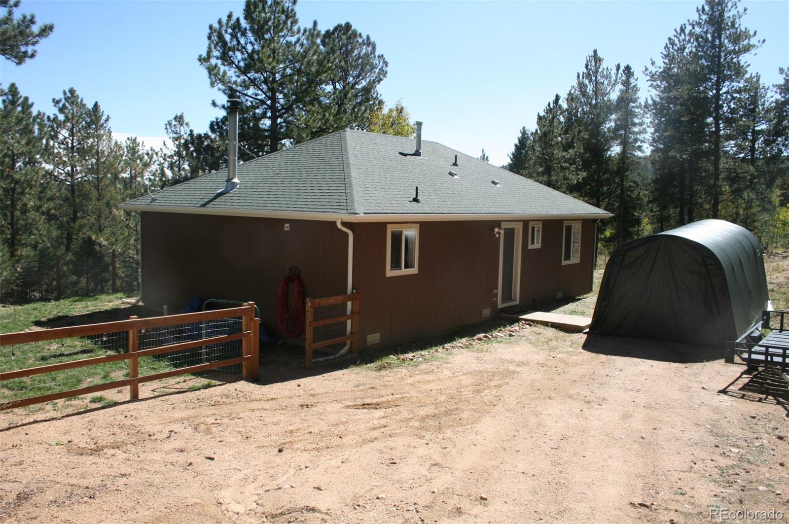 238 Taylor Street Bailey, CO 80421 - Photo 3 of 23 a front view of a house with a yard