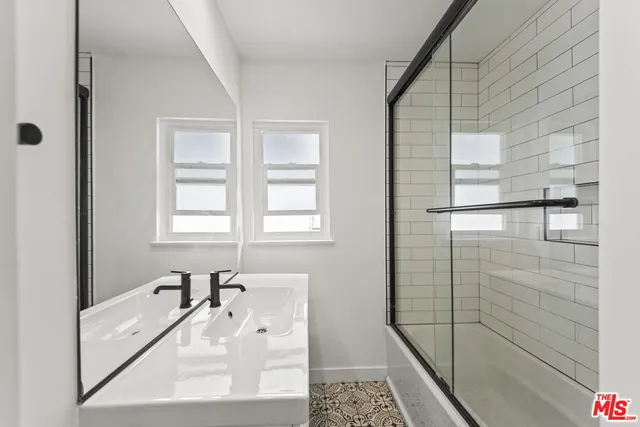 a bathroom with a tub sink and shower