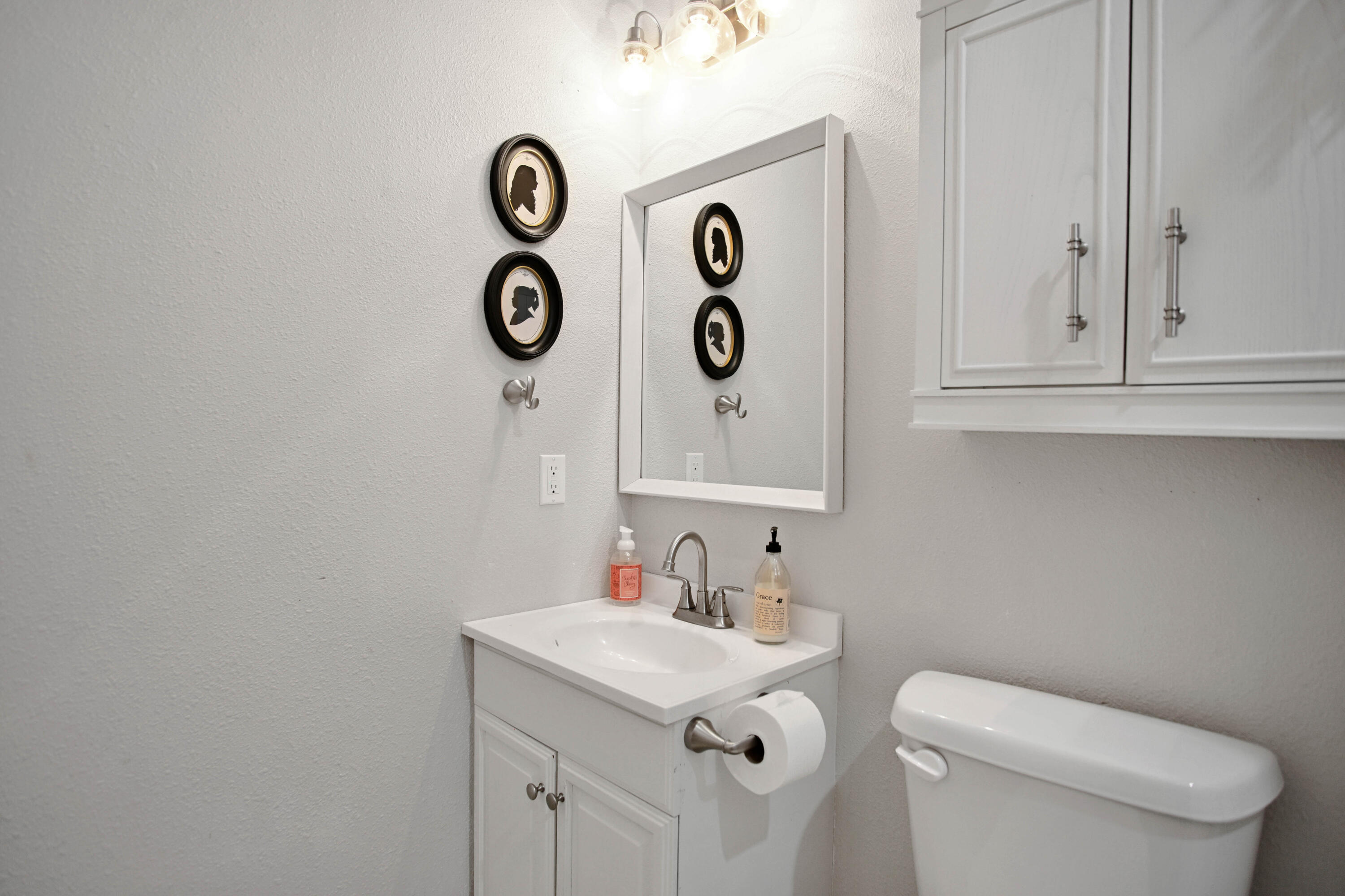 3091 County Road 3 Slaton, TX 79364 - Photo 27 of 41 a bathroom with a toilet sink vanity and mirror