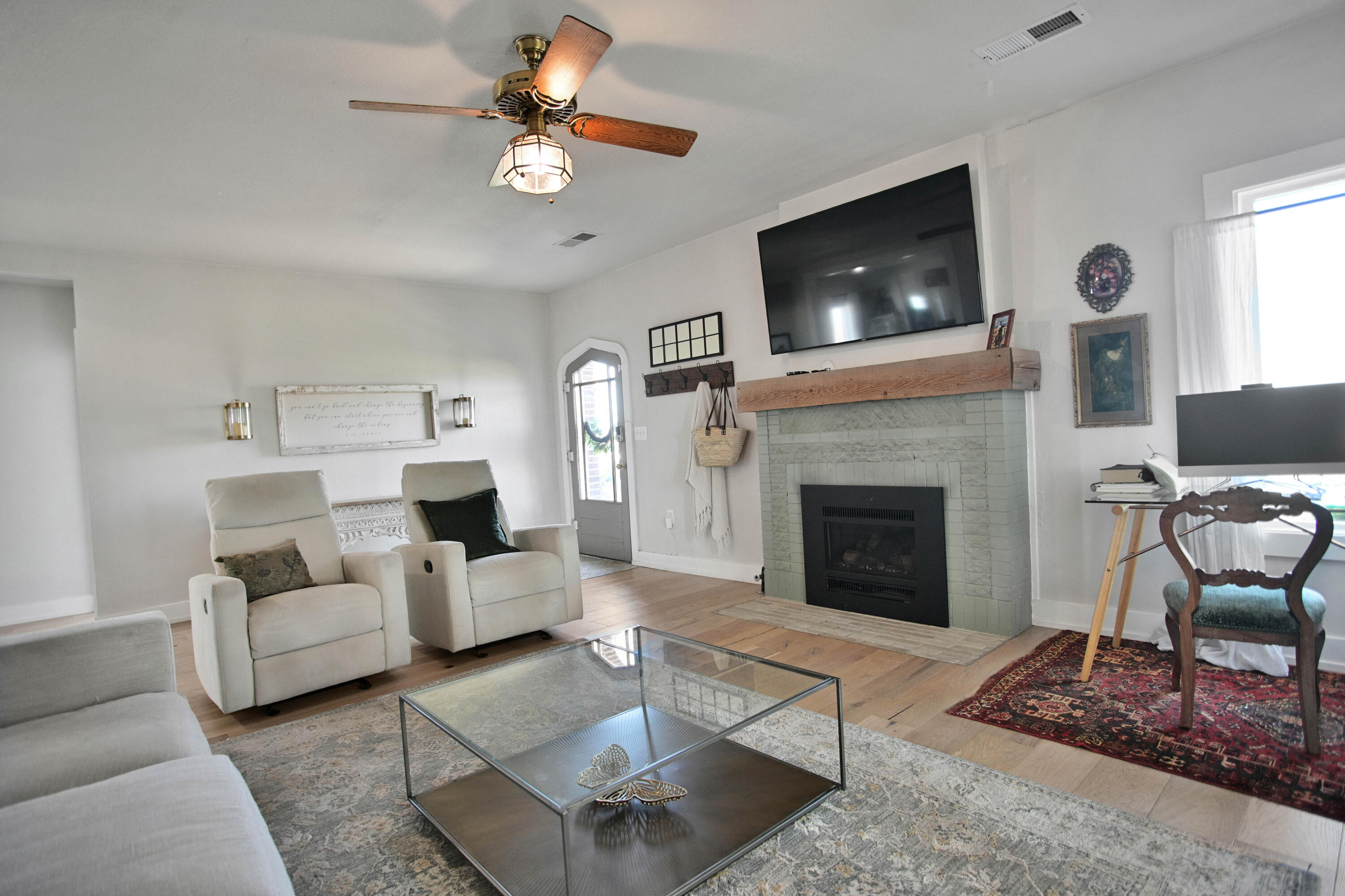 3091 County Road 3 Slaton, TX 79364 - Photo 3 of 41 a living room with furniture a flat screen tv and a fireplace