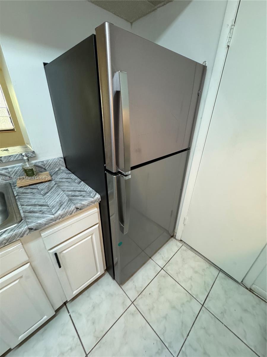 4341 West McNab Road, Unit 27 Pompano Beach, FL 33069 - Photo 12 of 50 a view of kitchen with refrigerator stove and sink