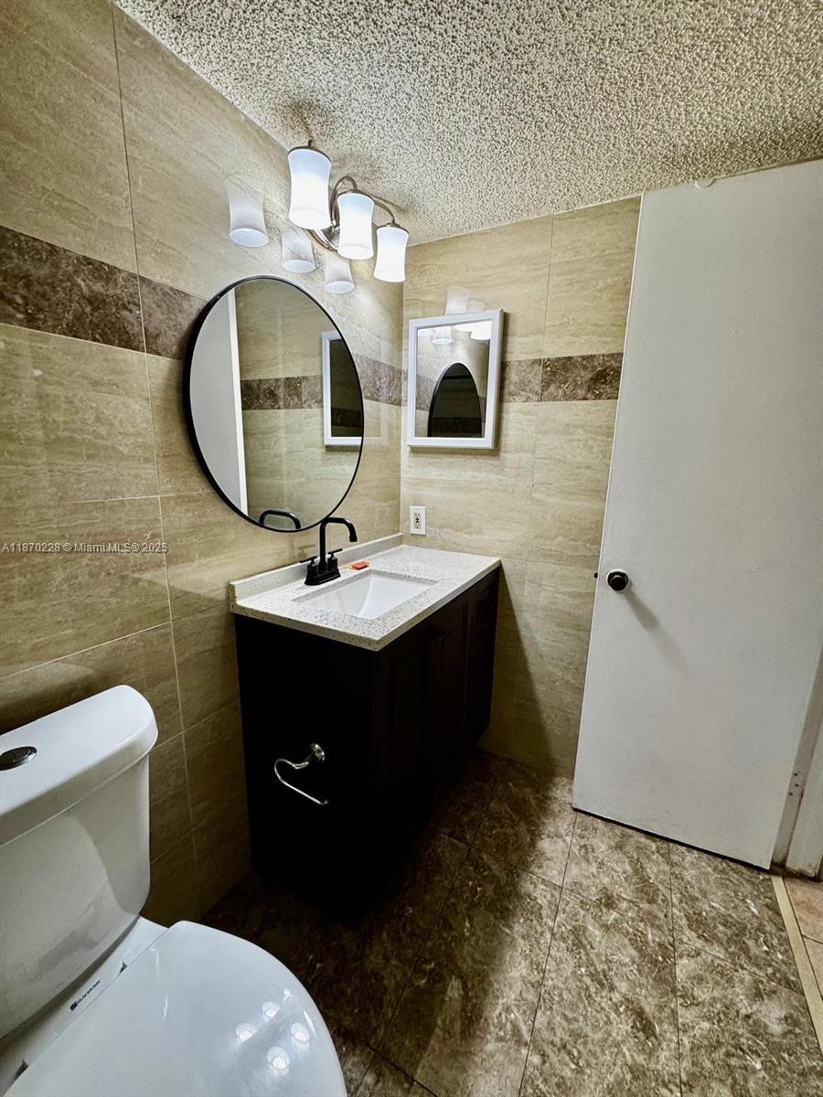 4341 West McNab Road, Unit 27 Pompano Beach, FL 33069 - Photo 23 of 50 a bathroom with a sink and a mirror