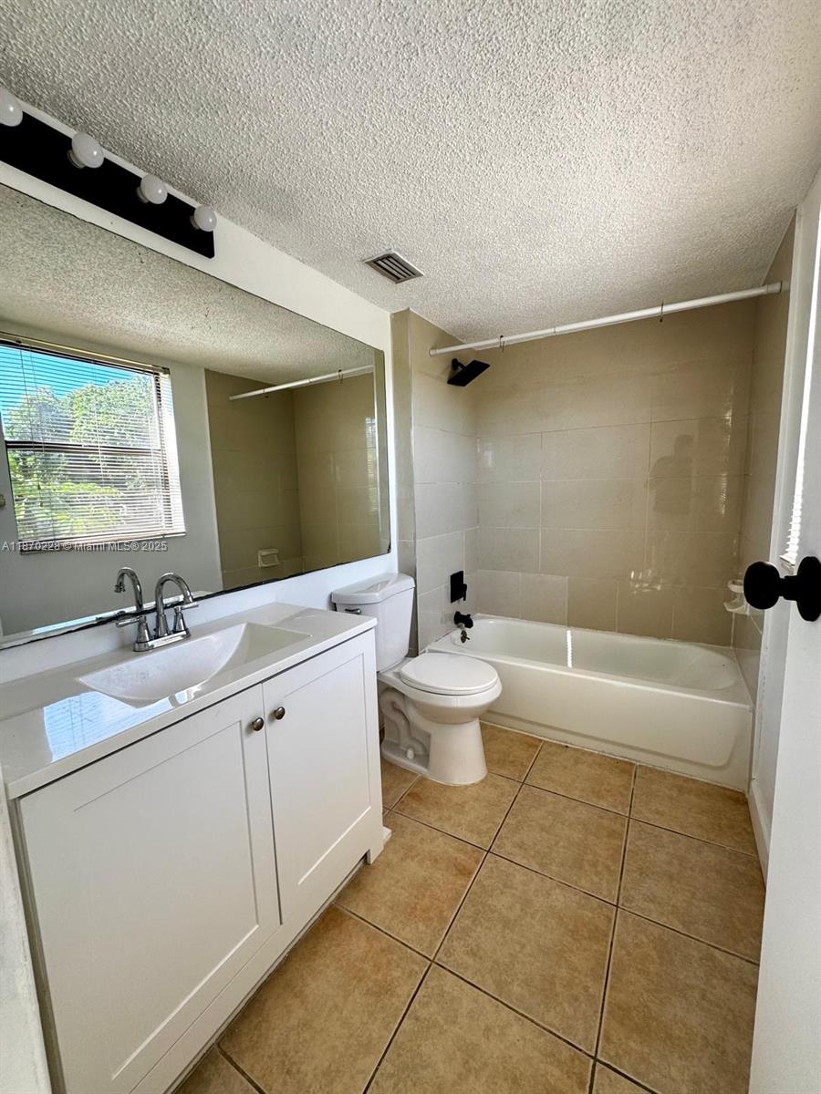 4341 West McNab Road, Unit 27 Pompano Beach, FL 33069 - Photo 29 of 50 a spacious bathroom with a bathtub sink mirror vanity and toilet