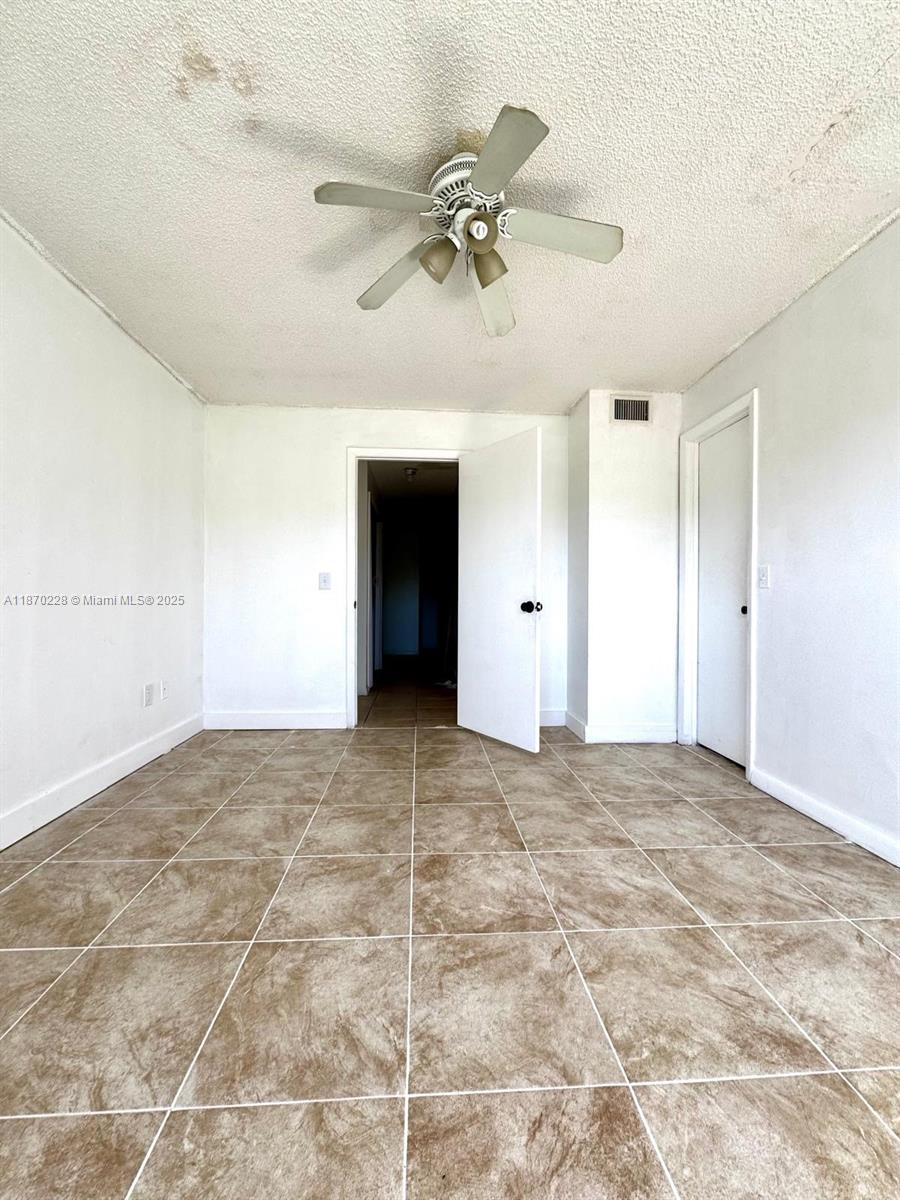 4341 West McNab Road, Unit 27 Pompano Beach, FL 33069 - Photo 32 of 50 a view of an empty room with a ceiling fan