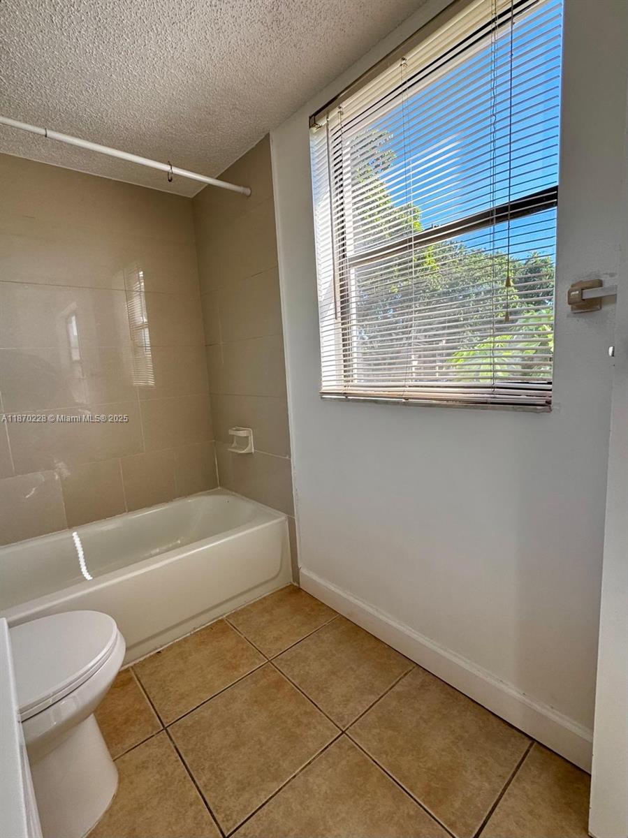 4341 West McNab Road, Unit 27 Pompano Beach, FL 33069 - Photo 33 of 50 a bathroom with a bathtub a toilet and a shower