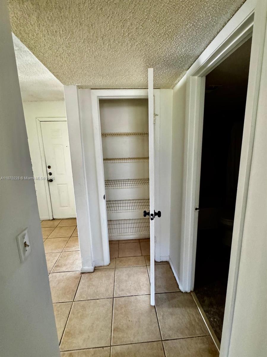 4341 West McNab Road, Unit 27 Pompano Beach, FL 33069 - Photo 35 of 50 a view of walk in closet with empty racks