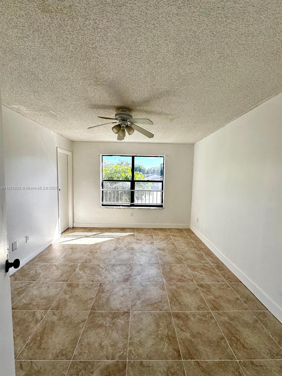 4341 West McNab Road, Unit 27 Pompano Beach, FL 33069 - Photo 39 of 50 an empty room with a empty space and windows