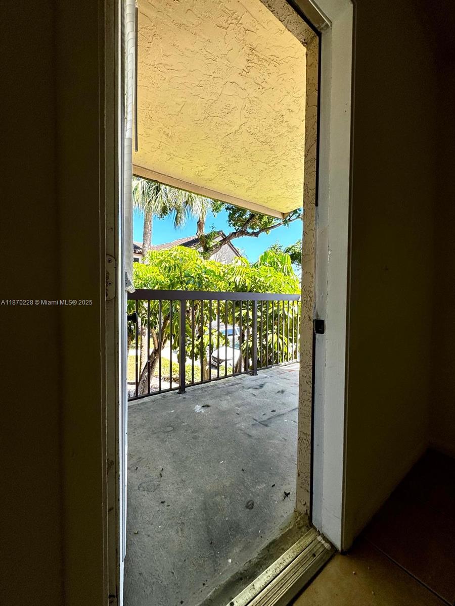 4341 West McNab Road, Unit 27 Pompano Beach, FL 33069 - Photo 44 of 50 a view of a glass door and porch