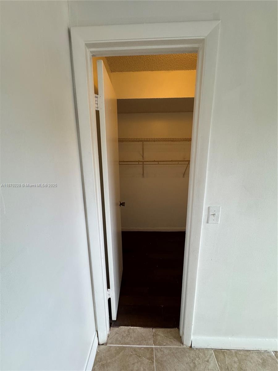 4341 West McNab Road, Unit 27 Pompano Beach, FL 33069 - Photo 9 of 50 a hallway with a door in front of it