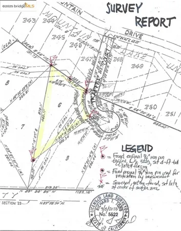 a view of a lake with boats and trees all around