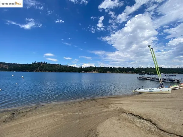 a view of swimming pool with outdoor seating and yard in back