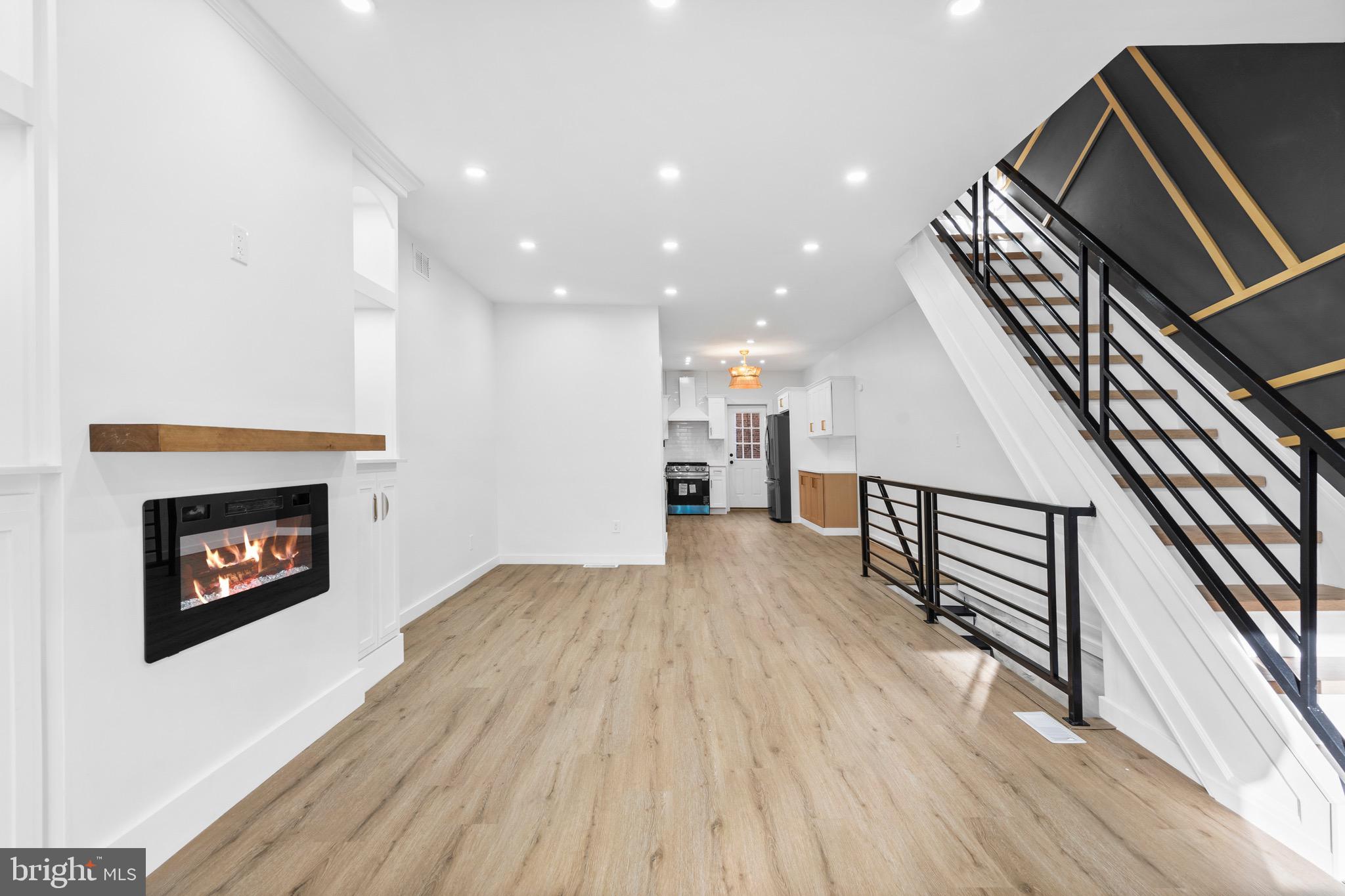 5541 Race Street Philadelphia, PA 19139 - Photo 1 of 37 a view of an empty room with wooden floor a fireplace and a window