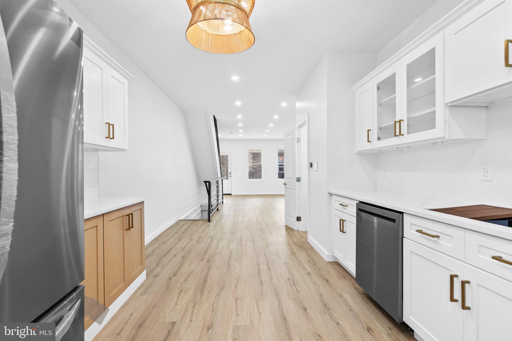 5541 Race Street Philadelphia, PA 19139 - Photo 11 of 37 a view of a kitchen with a white wooden cabinets and wooden floor