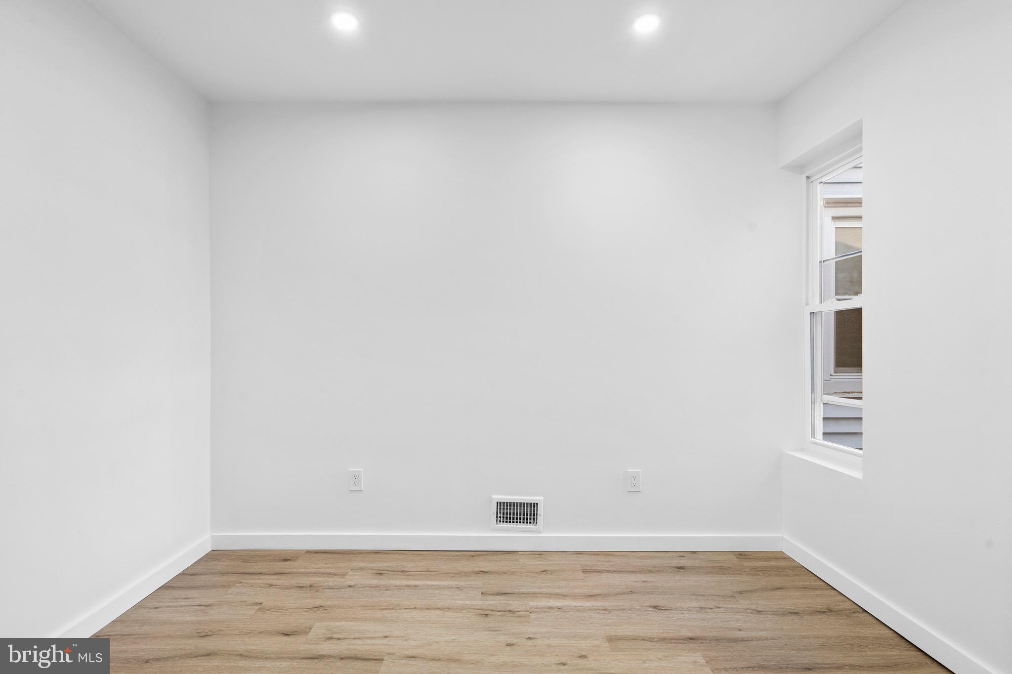 5541 Race Street Philadelphia, PA 19139 - Photo 13 of 37 a view of an empty room with wooden floor and a window