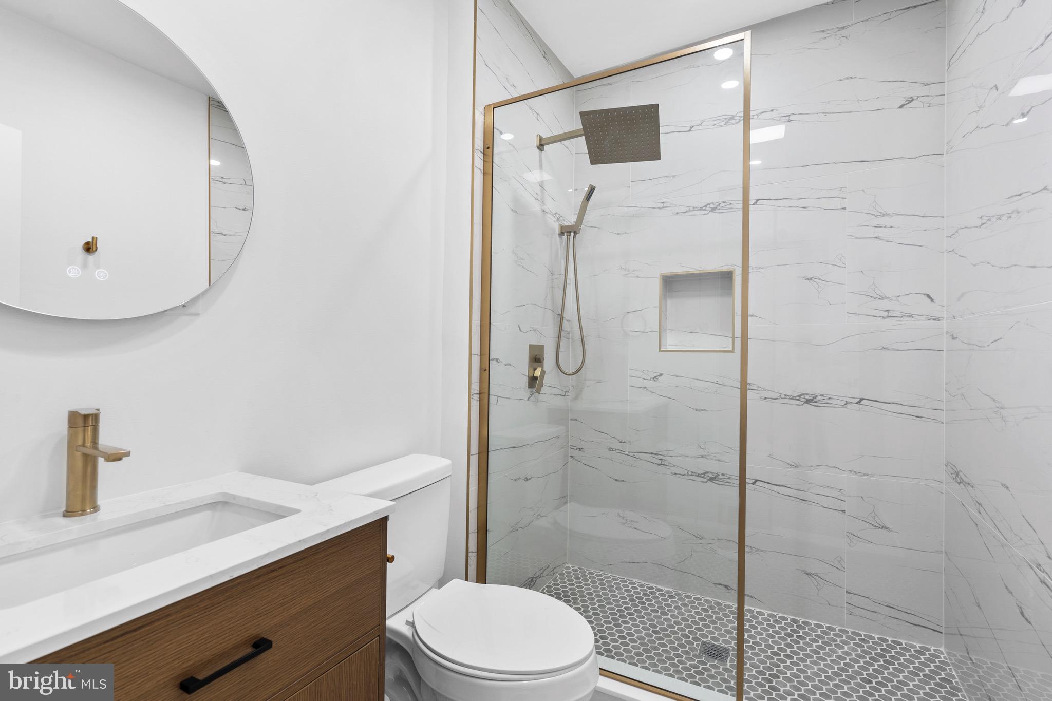 5541 Race Street Philadelphia, PA 19139 - Photo 15 of 37 a bathroom with a toilet a sink and shower