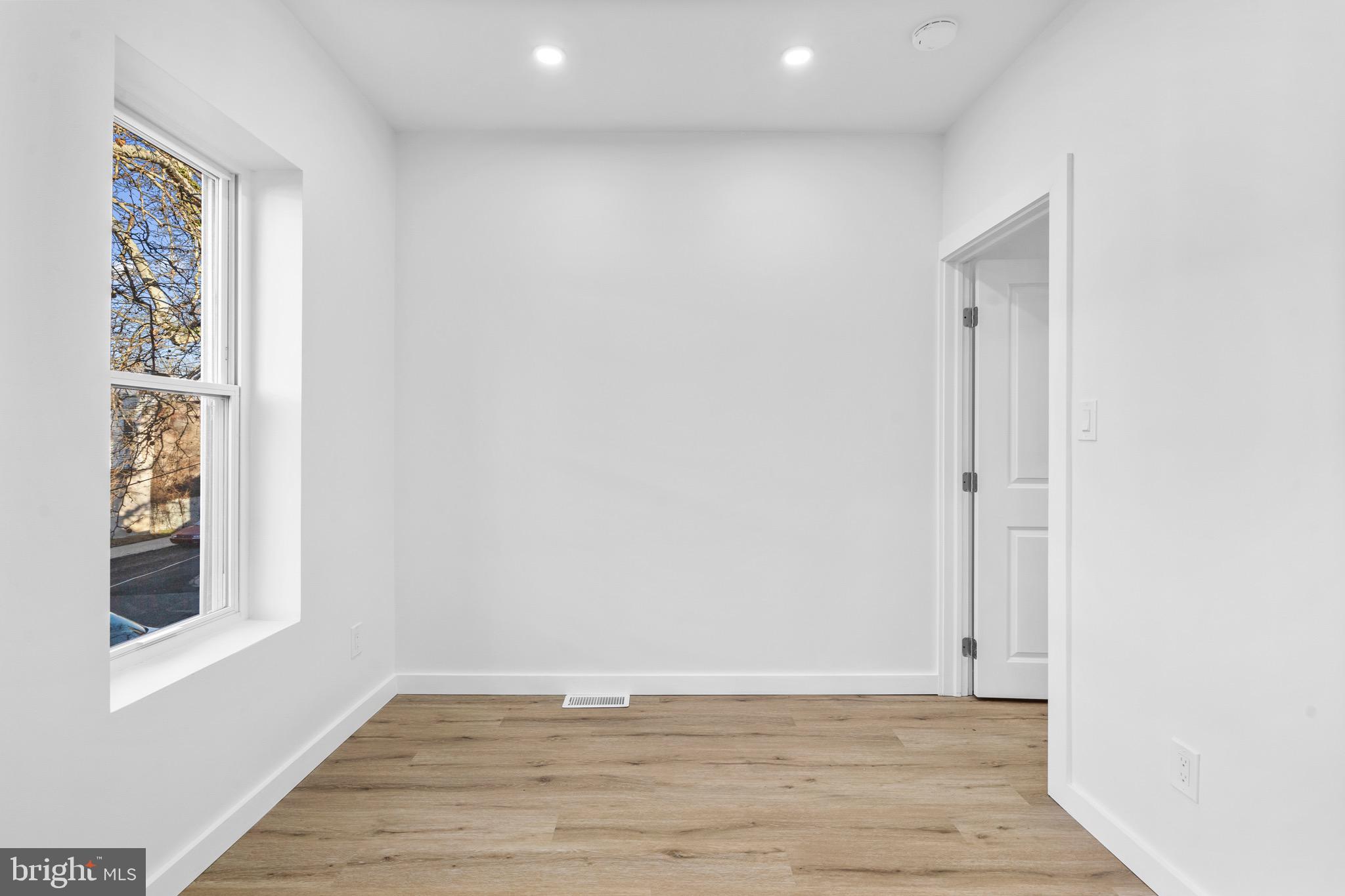 5541 Race Street Philadelphia, PA 19139 - Photo 16 of 37 a view of an empty room with wooden floor and a window