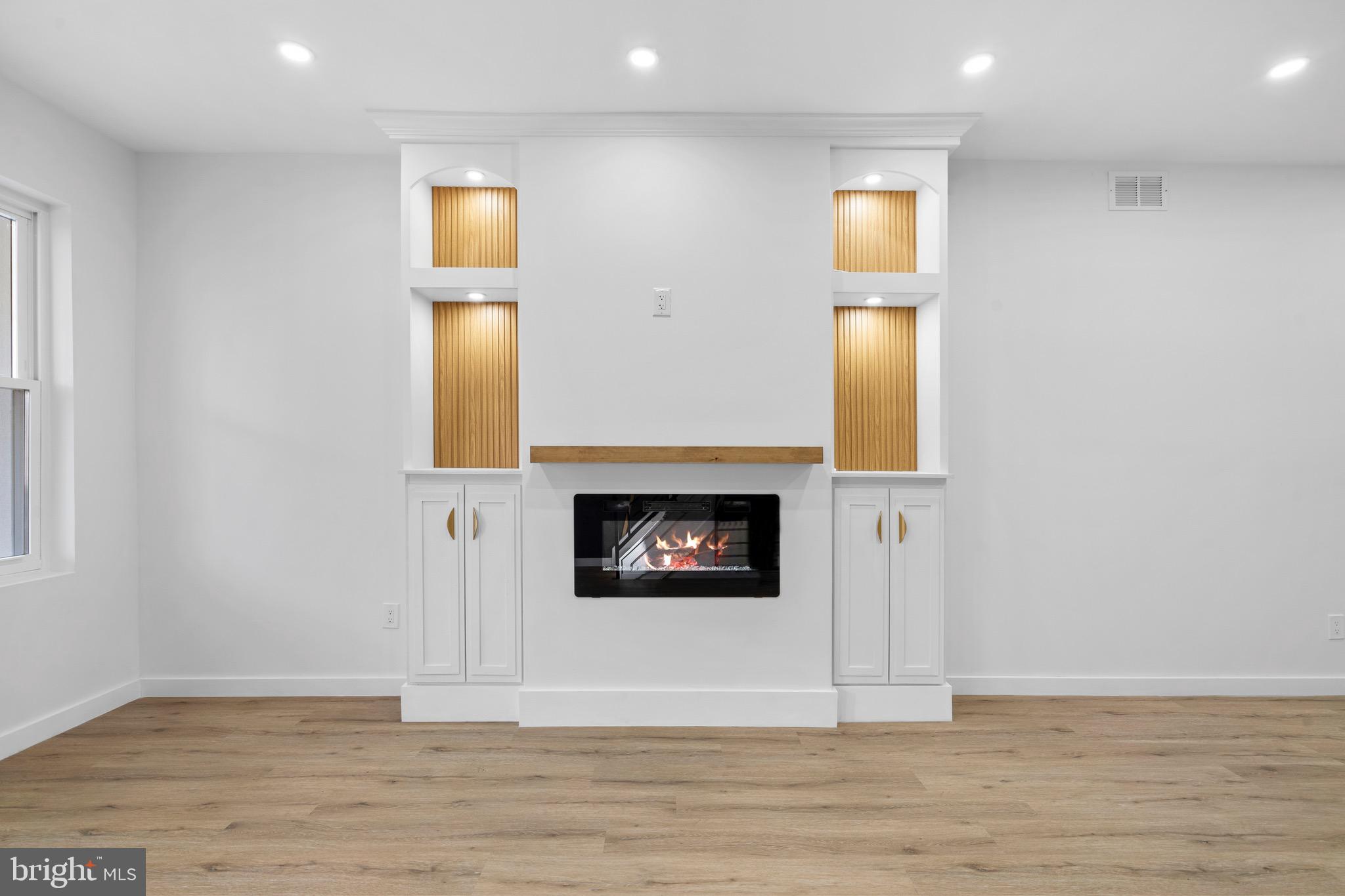 5541 Race Street Philadelphia, PA 19139 - Photo 3 of 37 a view of a hallway with wooden floor and a fireplace