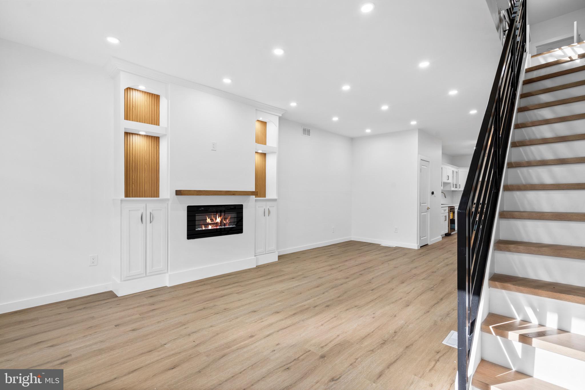 5541 Race Street Philadelphia, PA 19139 - Photo 4 of 37 wooden floor in an empty room with a fireplace