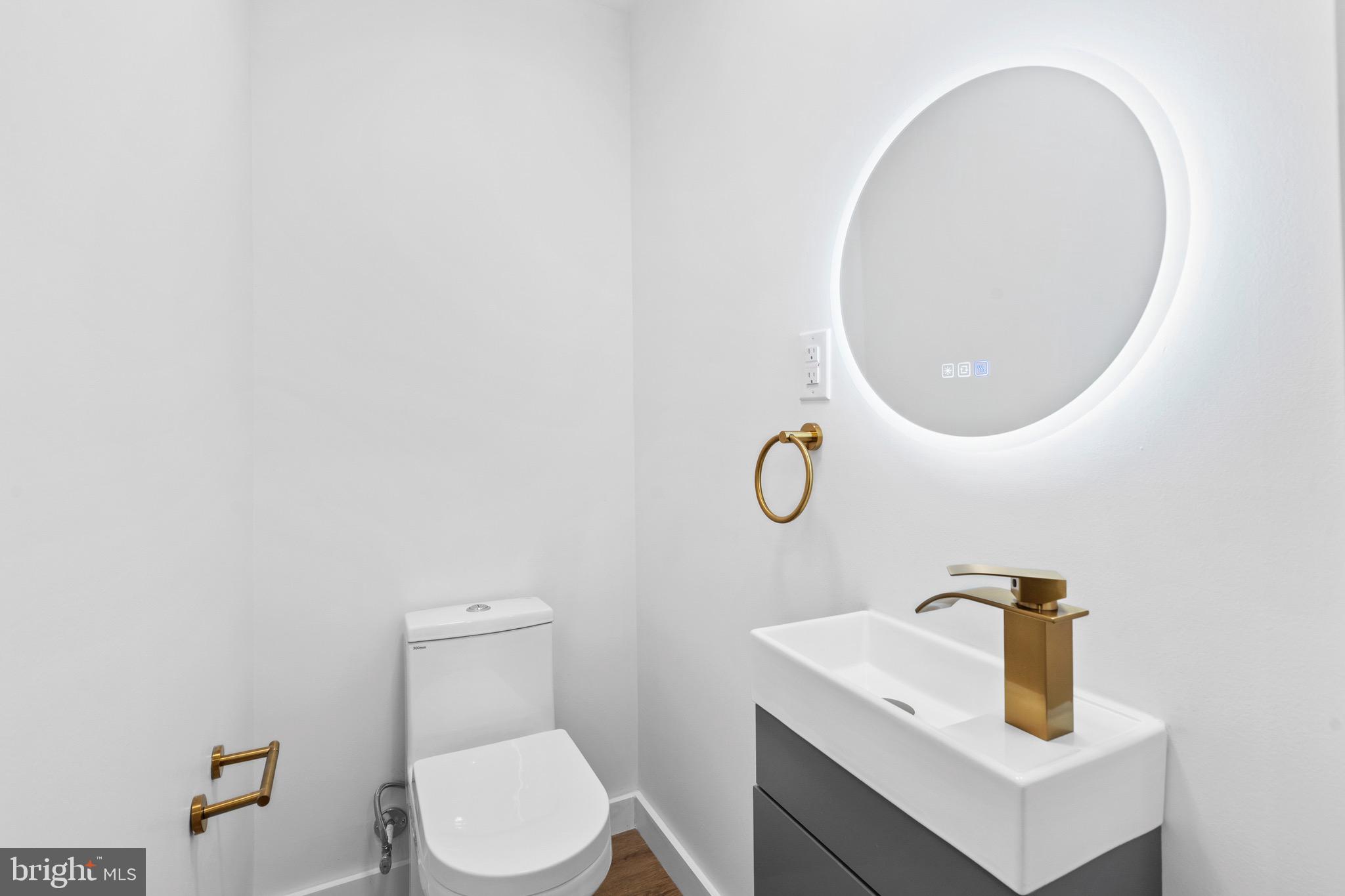 5541 Race Street Philadelphia, PA 19139 - Photo 7 of 37 a bathroom with a toilet sink and mirror